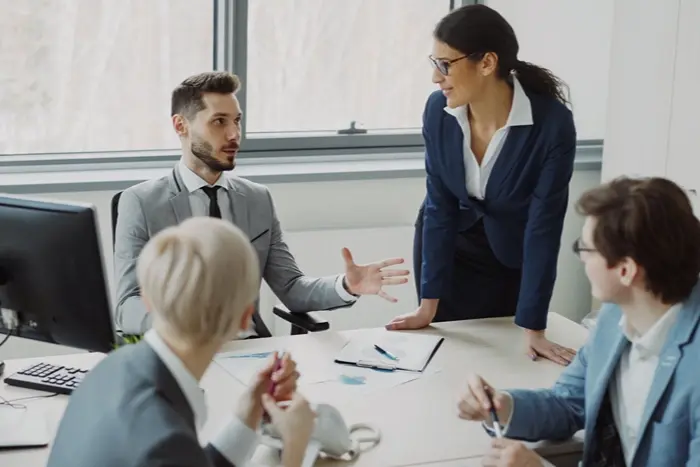 Leadership professionals discussing strategies in an office meeting while exploring leadership CPD courses and professional development opportunities