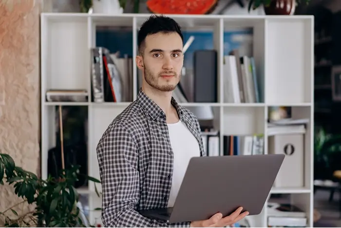 Professional using a laptop in a modern office, representing what CPD stands for and Continuing Professional Development.