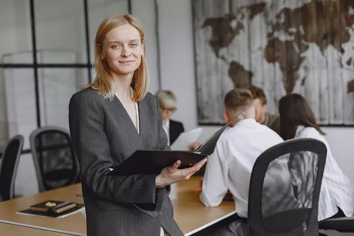 Business manager leading an office team, demonstrating business management skills and leadership skills for managers