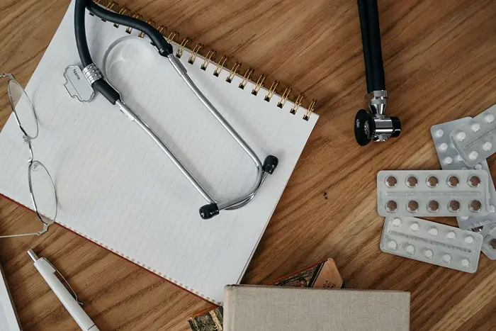 Medical notebook with stethoscope and healthcare tools representing Healthcare CPD requirements and professional standards.