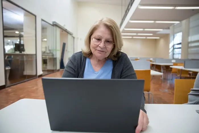 Professional completing online training, illustrating lifelong learning and continuing professional development for career growth.